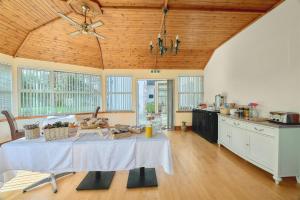 uma cozinha com uma mesa com uma toalha de mesa branca em Kinkell House B&B em Cononbridge