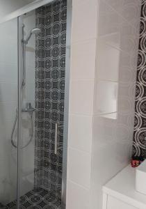 a bathroom with a shower with a glass door at Lantiana Gardens ApartHotel in Protaras