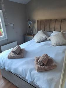 a bedroom with a bed with towels on it at No. 4 Sunny Lodge By The Sea in Aberystwyth