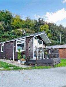 a small house with a porch and a fence at No. 4 Sunny Lodge By The Sea in Aberystwyth