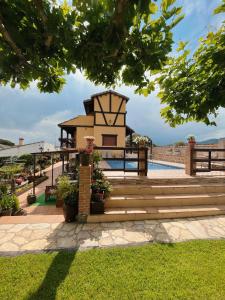 a resort with a pool and a building at La Garrocha in Colmenar del Arroyo