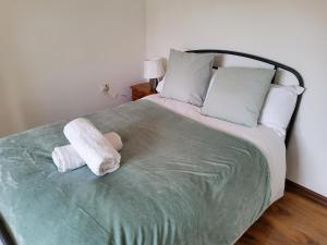 a bedroom with a bed with two towels on it at Impeccable 2-Bed House in Norwich in Norwich