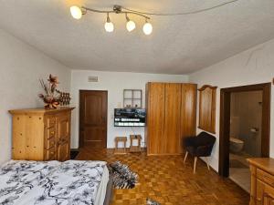 a bedroom with a bed and a desk and a chair at Apartment Aleks in Bach