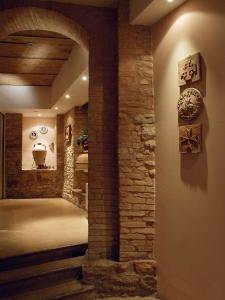 a hallway in a house with a stone wall at Giotto Hotel & Spa in Assisi