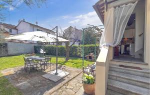 a patio with an umbrella and a table and chairs at 1 Bedroom Nice Home In Sansepolcro in Sansepolcro