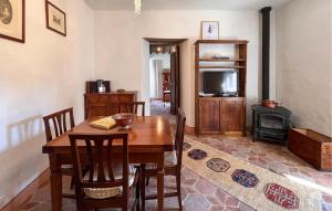 a dining room with a wooden table and a television at 1 Bedroom Nice Home In Sansepolcro in Sansepolcro