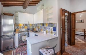 a kitchen with a refrigerator and a counter top at 1 Bedroom Nice Home In Sansepolcro in Sansepolcro