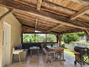 a patio with a couch and a table at Maison superbe sur 2 étages avec piscine in Celles