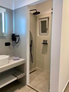a bathroom with a shower and a sink at Asteras Mini Suites in Naousa