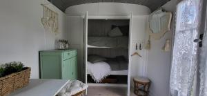 a room with a small bedroom with a bunk bed at Petit a Petit - gypsy wagons and Bell tents in the Bourgogne in Saisy