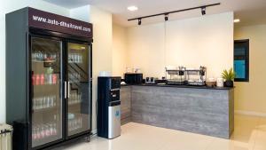 a coffee shop with a counter and a refrigerator at THE BOSS HOTEL CHIANGMAl in Chiang Mai