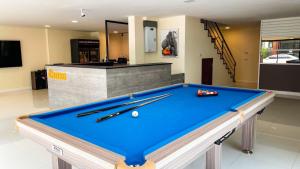 a pool table in a room with cues on it at THE BOSS HOTEL CHIANGMAl in Chiang Mai