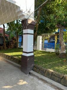 a pole in front of a park with a fence at Loidas Place in Talisay