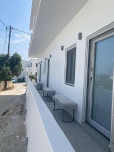 a row of benches on the side of a building at Asteras Mini Suites in Naousa