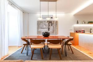 a dining room with a wooden table and chairs at Outstanding Santos Spacious 2 Bedroom Apt w AC in Lisbon