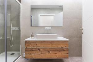 a bathroom with a sink and a mirror at Outstanding Santos Spacious 2 Bedroom Apt w AC in Lisbon +30 photos