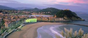 a view of a beach with buildings and a city at Hotel Parma in San Sebastián