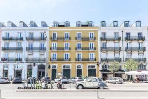 a car parked in front of a yellow building at Outstanding Santos Spacious 2 Bedroom Apt w AC in Lisbon