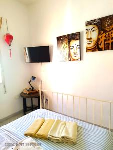 a bedroom with a bed with two pictures on the wall at Casapatrizia Appartamento compartido in Santa Cruz de Tenerife