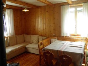 a living room with a couch and a table at Bormio Flat in Bormio