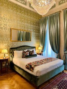 a bedroom with a bed and a chandelier at Palazzo Monga Boutique Guesthouse in Verona