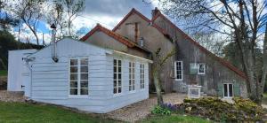 a small white building next to a house at Petit a Petit - gypsy wagons and Bell tents in the Bourgogne in Saisy
