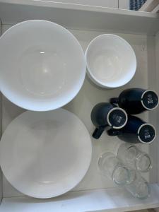 a shelf with white plates and cups on it at Leisure Home-1Bedroom in Masai