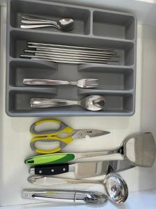 a drawer full of kitchen utensils in a drawer at Leisure Home-1Bedroom in Masai