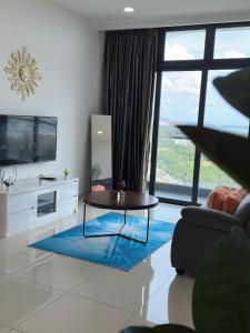 a living room with a table and a large window at Leisure Home-1Bedroom in Masai