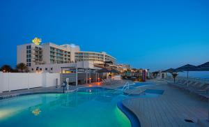 a swimming pool at a resort at night at Hard Rock Hotel Daytona Beach in Daytona Beach