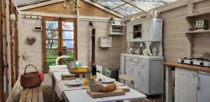 a kitchen with a table in a greenhouse at Petit a Petit - gypsy wagons and Bell tents in the Bourgogne in Saisy +28 photos