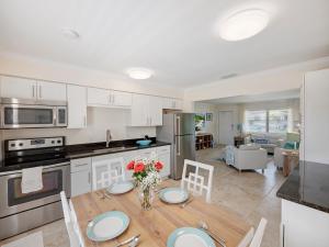 a kitchen and living room with a table and chairs at Bright and Sunny 2BR !!Close to Peanut Island!! in Riviera Beach