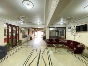 a living room with a couch and a table at Hotel City Plaza, Srinagar in Srinagar