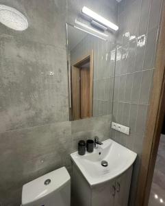 y baño con lavabo, aseo y espejo. en VISTA Apartment en Mińsk Mazowiecki