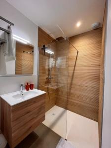 a bathroom with a sink and a shower at L'Eden des Aspres in Thuir