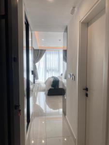 a hallway leading to a bedroom with a bed at Kass Towers, Studio Apartment in Accra