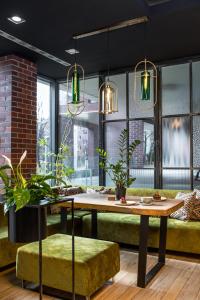 a dining room with a table and a couch at Invite in Wrocław