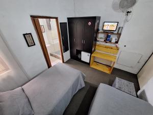 una piccola camera con due letti e una televisione di Villa Ocean Crest B&B a Gansbaai