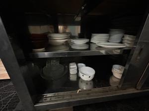 a cabinet full of dishes and bowls and plates at 高島市安曇川町琵琶湖徒歩3分エクシブ 高島 近くBbQ自転車無料貸出 in Takashima