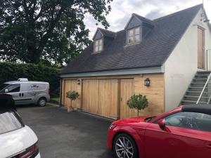 a car parked in a parking lot in front of a house at Stunning studio flat with own large garden in Shrewsbury SLEEPS 2 in Shrewsbury