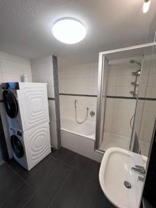 a bathroom with a tub and a sink and a shower at City Unterkunft 5 in Heilbronn +14 photos