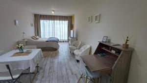 a living room with a bed and a table and chairs at FerPilar Suite, Concord Pilar in Pilar +33 photos