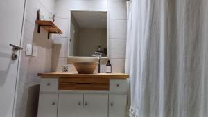 a bathroom with a sink and a shower curtain at FerPilar Suite, Concord Pilar in Pilar