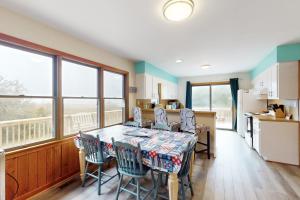 a kitchen and dining room with a table and chairs at Seaclusion in Frisco