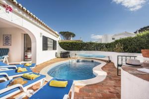 a pool with chaise lounge chairs and a swimming pool at Mng Elliott55 in Vale do Lobo
