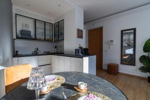 a kitchen and dining room with a glass table at Ausblick Kleinjuwel mit Panoramablick + Garage in Merano