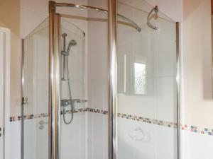 a shower with a glass door in a bathroom at 4 The Glade in Wadebridge