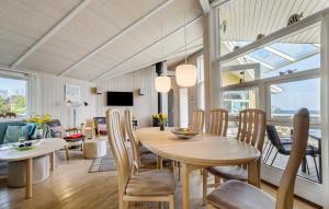 4 Bedroom Gorgeous Home In Sydals في Skovby: غرفة طعام وغرفة معيشة مع طاولة وكراسي