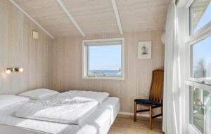 a bedroom with two beds and a window at Holiday Home Sydals 57 With Hot Tub in Skovby +14 photos