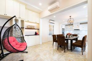 a kitchen and dining room with a swing in a room at KN2 HOLIDAY VILLA in Ho Chi Minh City